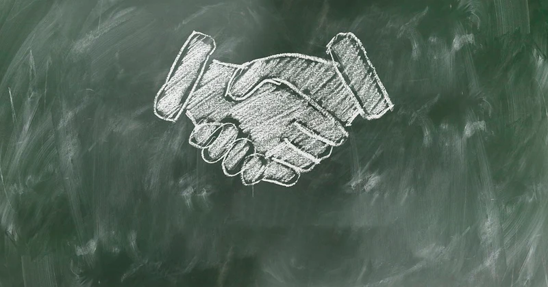 Tegning at to der giver hånd